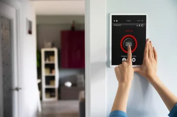 A smart home security system with a tablet in the wall of the entrance of a room