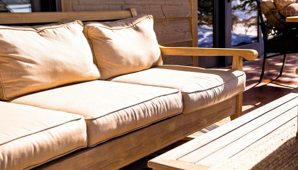 brown wooden futon placed near coffee table