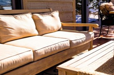 brown wooden futon placed near coffee table